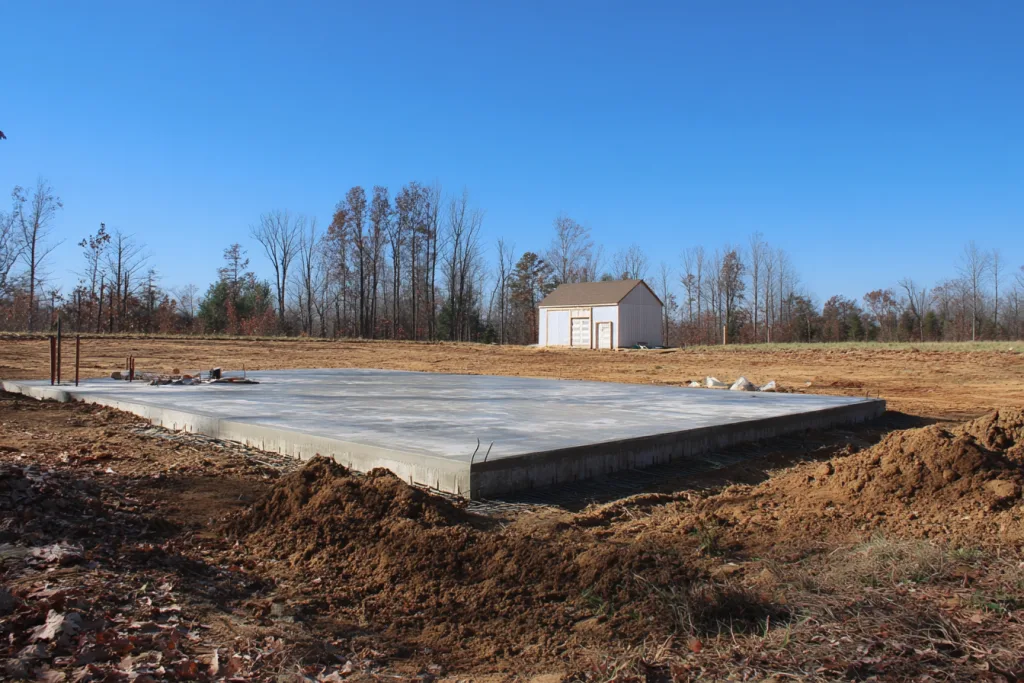 reinforced concrete slab foundation for barndominium construction ready for framing stage timeline