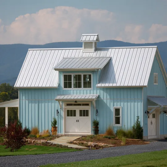 light blue barndominium with vertical metal siding and standing seam metal roof in rural mountain setting